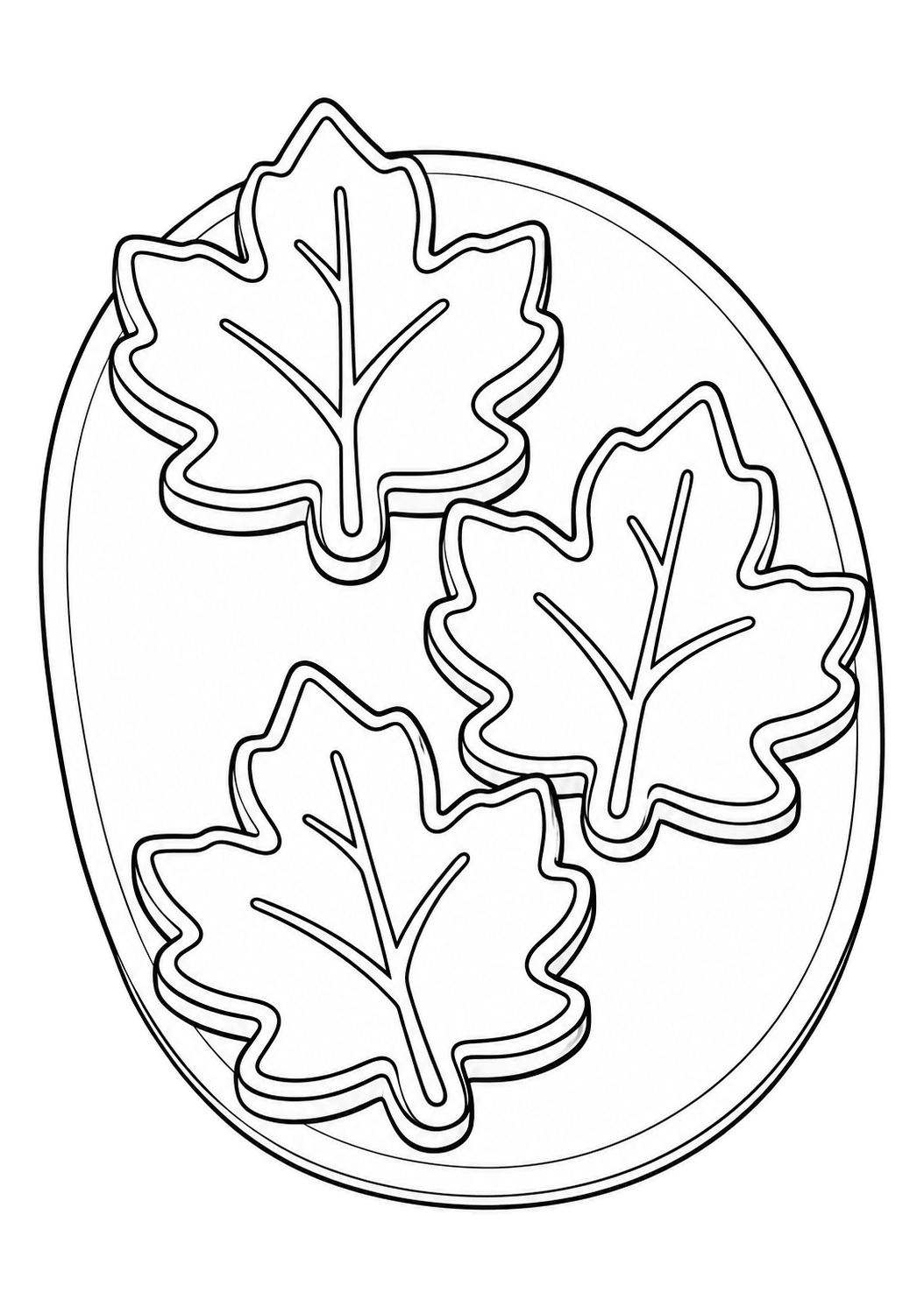 Trois biscuits en forme de feuilles d’érable, ornés de glaçage et de nervures, sont disposés sur une assiette ovale.